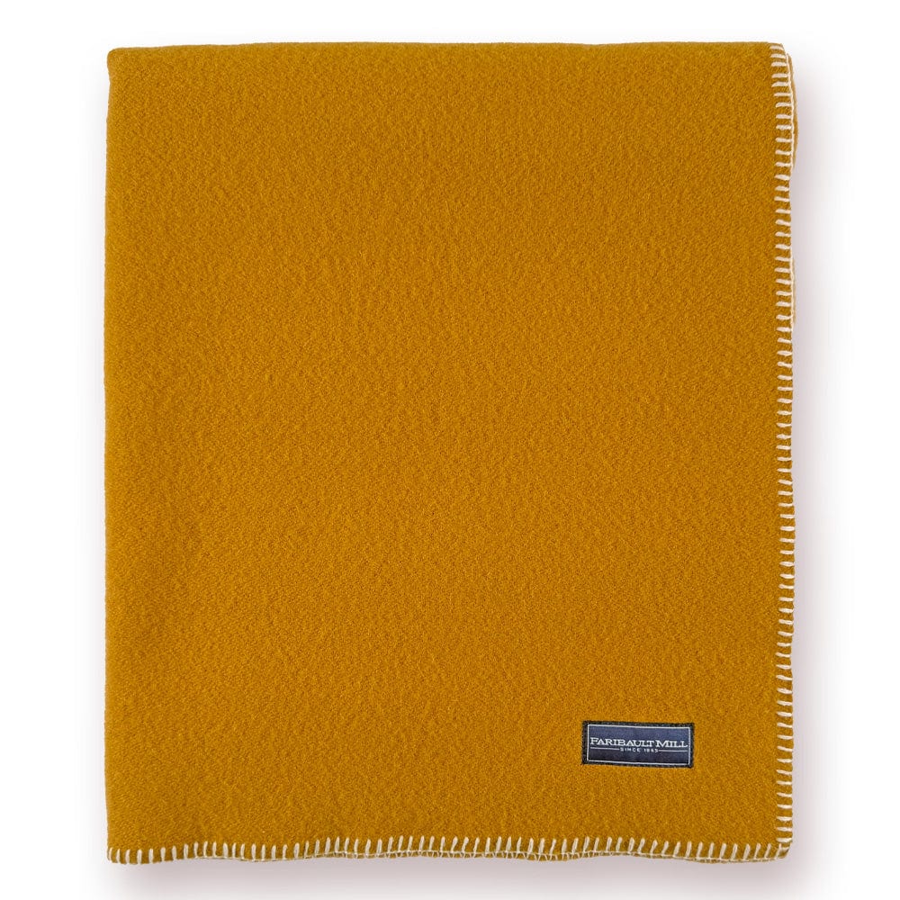 Faribault Mill Pure and Simple butterscotch middleweight wool bed blanket, folded and displayed in a top-down view.