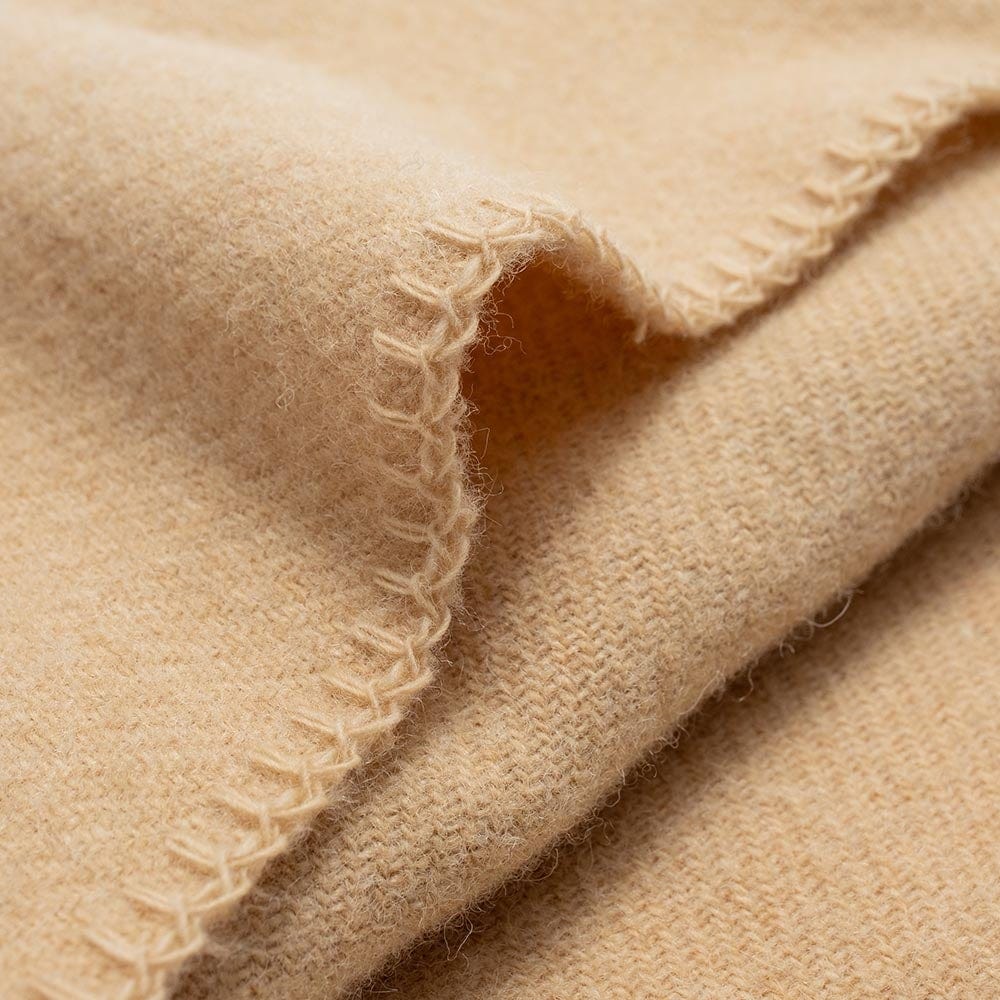 Faribault Mill Pure and Simple camel middleweight wool bed blanket, displayed close-up showing the weave, texture, and edge finish.